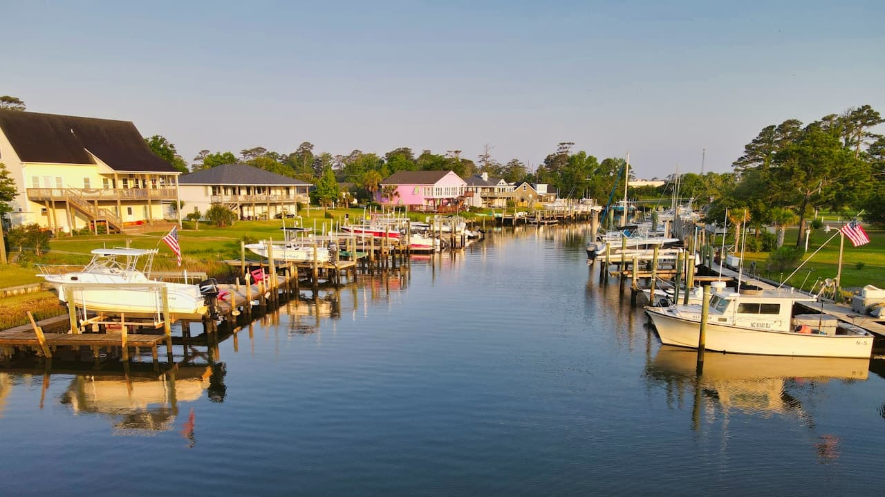Boats and waterfront homes on a North Carolina lake at golden hour